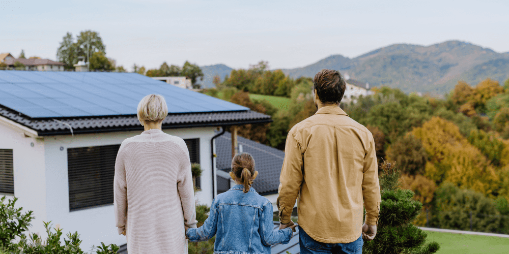 A family admiring solar panels